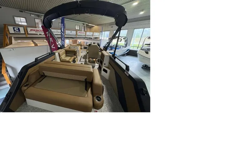 Slide: The Image of 2026 Revel RS25 boat interior with tan seating in showroom. - 4