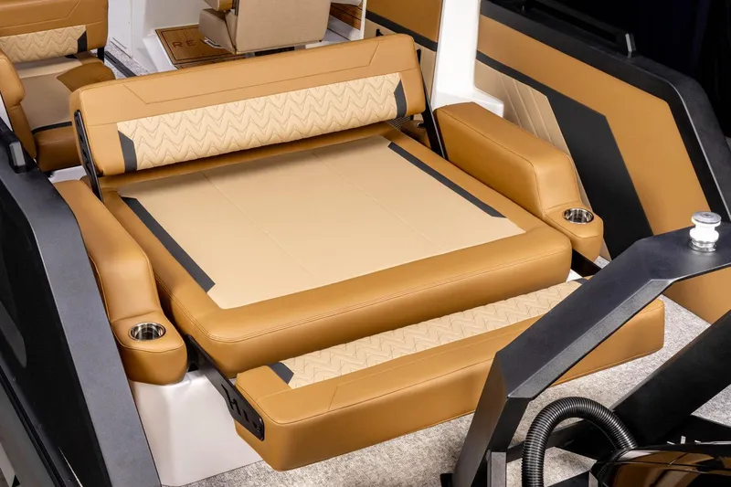Slide: The Image of Manufacturer Provided Image: Luxurious interior of 2026 Revel RS25 boat with tan leather seating and cup holders. - 9