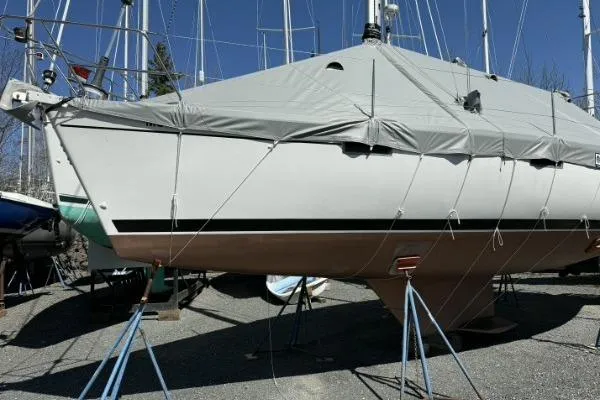 Slide: The Image of 1991 Beneteau Oceanis 370 sailboat covered and supported on stands in a boatyard. - 10