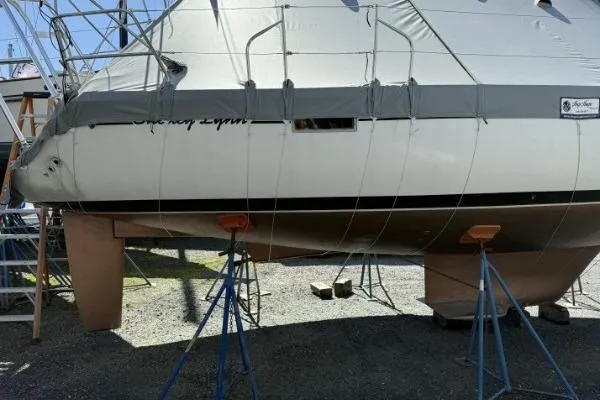 Slide: The Image of 1991 Beneteau Oceanis 370 sailboat on stands, covered and ready for maintenance. - 11