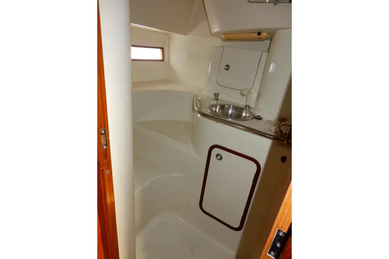 Slide: The Image of Interior of 1991 Beneteau Oceanis 370 yacht bathroom with sink and storage. - 19