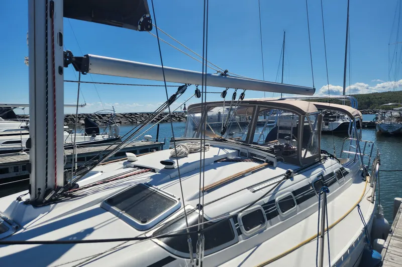 Slide: The Image of 1991 Beneteau Oceanis 370 sailboat docked at marina under clear blue sky. - 2