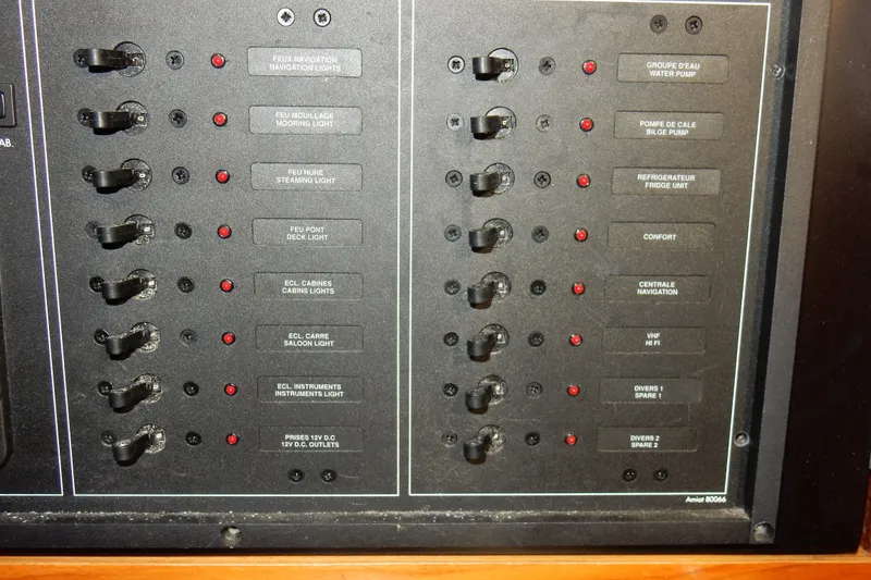 Slide: The Image of Control panel of a 1991 Beneteau Oceanis 370 sailboat with labeled switches. - 27