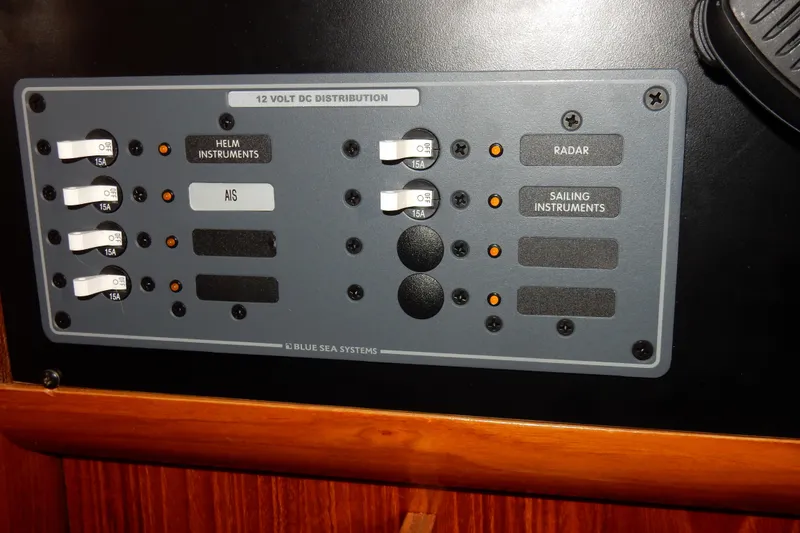 Slide: The Image of Control panel of a 1991 Beneteau Oceanis 370 sailboat, featuring instrument switches. - 28