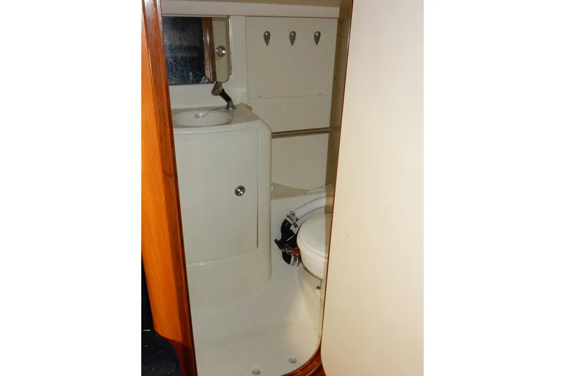 Slide: The Image of Bathroom interior of 1991 Beneteau Oceanis 370 sailboat, featuring compact sink and toilet. - 34