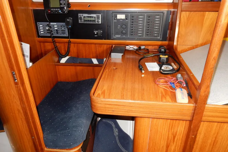 Slide: The Image of Navigation station of 1991 Beneteau Oceanis 370 sailboat with control panels and equipment. - 36