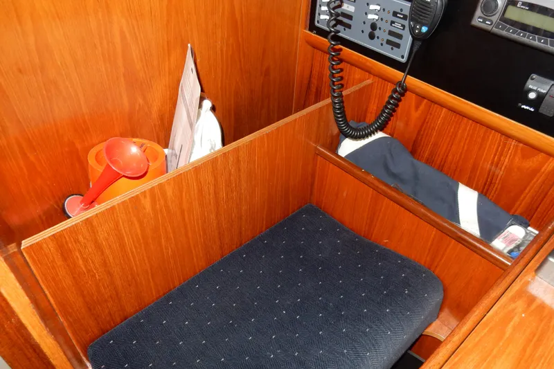 Slide: The Image of Interior of 1991 Beneteau Oceanis 370 sailboat with wooden paneling and navigation equipment. - 37