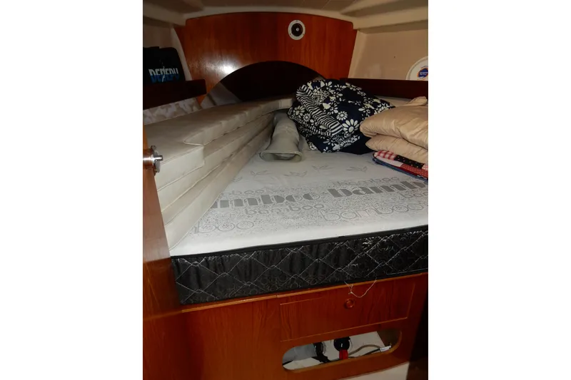 Slide: The Image of Cozy cabin interior of 1991 Beneteau Oceanis 370 sailboat with bedding and storage. - 39