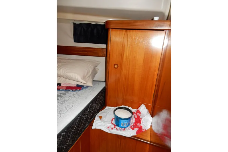 Slide: The Image of Interior cabin of 1991 Beneteau Oceanis 370 with wooden cabinetry and bedding. - 40
