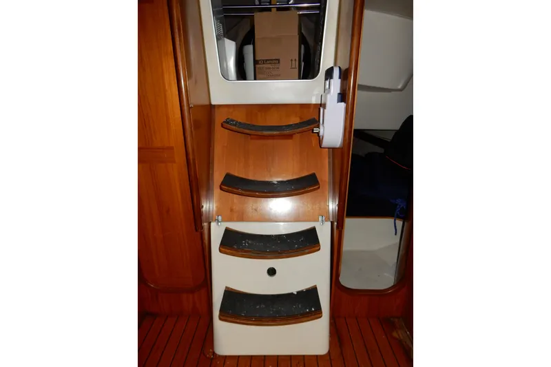Slide: The Image of Interior stairs of 1991 Beneteau Oceanis 370 sailboat, featuring wooden steps and cabin entry. - 41
