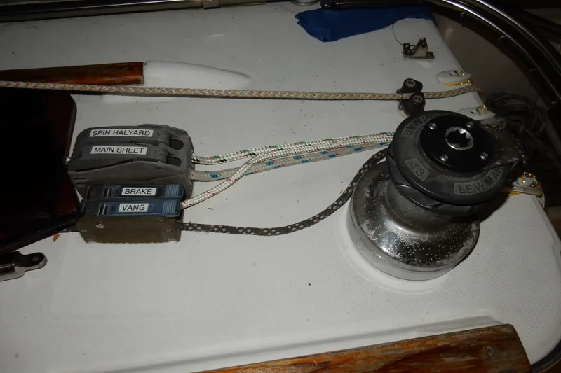 Slide: The Image of Sailing equipment on a 1991 Beneteau Oceanis 370, featuring winch and labeled rope clutches. - 43