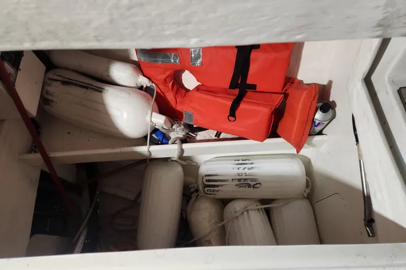 Slide: The Image of Storage compartment of 1991 Beneteau Oceanis 370 with life jackets and fenders. - 46