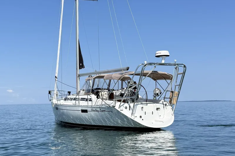 Slide: The Image of 1991 Beneteau Oceanis 370 sailboat on calm blue water under clear sky. - 5