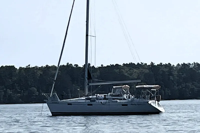 Slide: The Image of Sailboat on water, 1991 Beneteau Oceanis 370, forested shoreline in background. - 6
