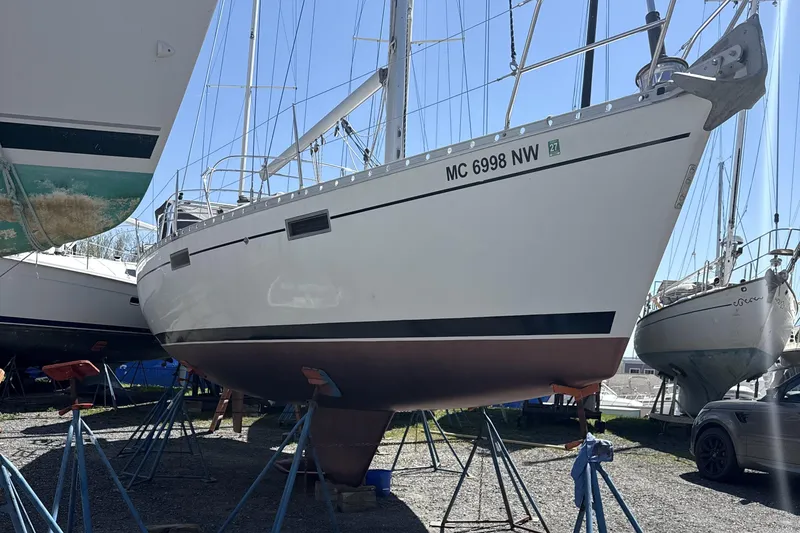 Slide: The Image of 1991 Beneteau Oceanis 370 sailboat on stands in a boatyard. - 9