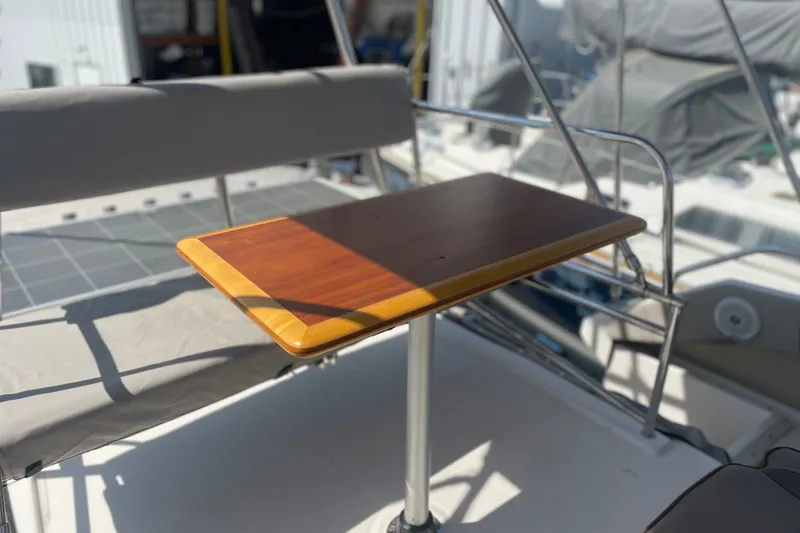 Slide: The Image of 2021 Cutwater C-32 CB boat with wooden table and cushioned seating on deck. - 14