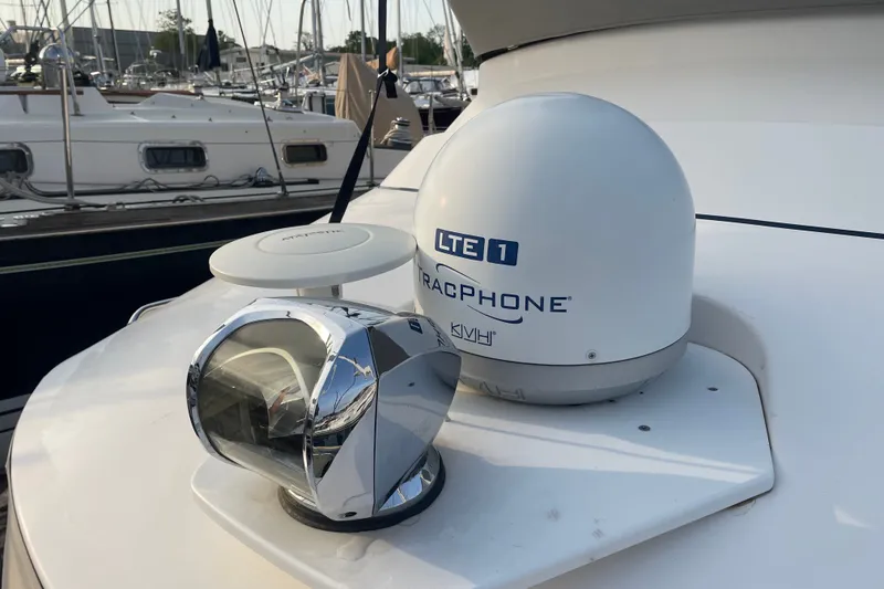 Slide: The Image of 2021 Cutwater C-32 CB yacht with marine communication equipment and radar, docked at a marina. - 20