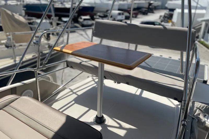 Slide: The Image of Flybridge seating area on a 2021 Cutwater C-32 CB boat with a wooden table. - 16