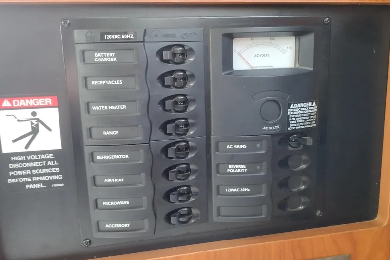 Slide: The Image of Electrical panel of a 2005 Bayliner 305 boat with labeled switches and voltage meter. - 20