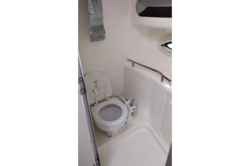Slide: The Image of Compact bathroom in 2005 Bayliner 305 boat with toilet and handrail. - 28