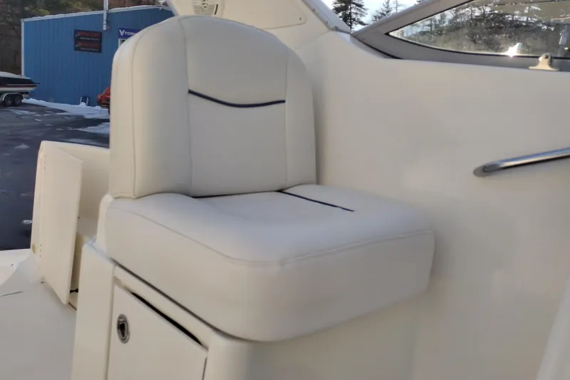 Slide: The Image of White leather seat on 2005 Bayliner 305 boat, with storage compartment. - 34