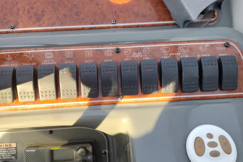 Slide: The Image of Control panel of a 2005 Bayliner 305 boat with labeled switches and buttons. - 36