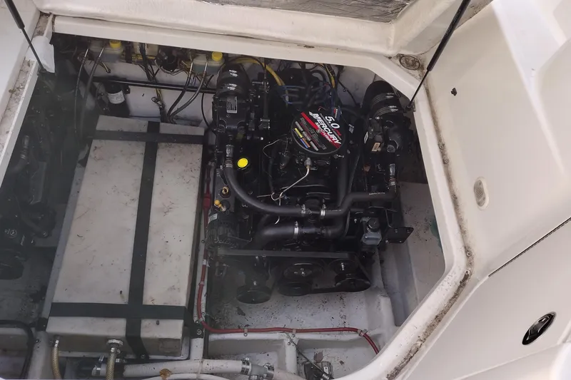 Slide: The Image of Engine compartment of a 2005 Bayliner 305 boat, featuring a 5.0L MerCruiser engine. - 37