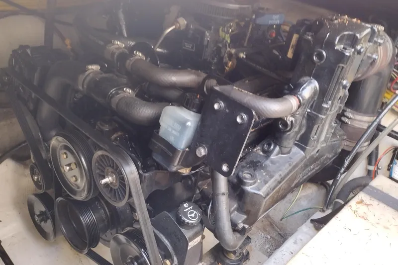 Slide: The Image of Engine compartment of a 2005 Bayliner 305 boat, showcasing mechanical components and hoses. - 39