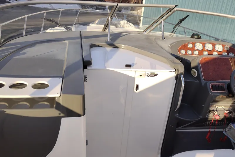 Slide: The Image of 2005 Bayliner 305 boat cockpit with dashboard and controls, featuring modern design elements. - 42