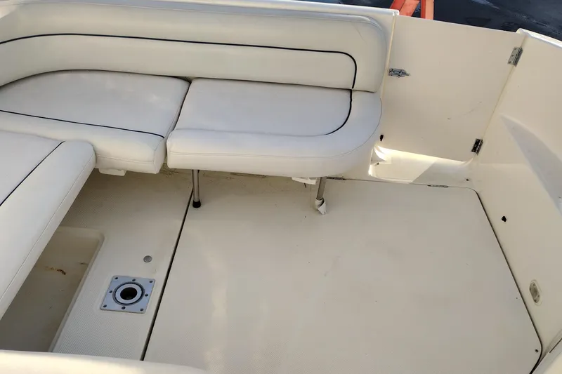 Slide: The Image of 2005 Bayliner 305 boat interior with white seating and clean deck area. - 44