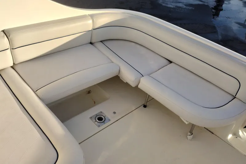 Slide: The Image of 2005 Bayliner 305 boat with white cushioned seating area. - 45