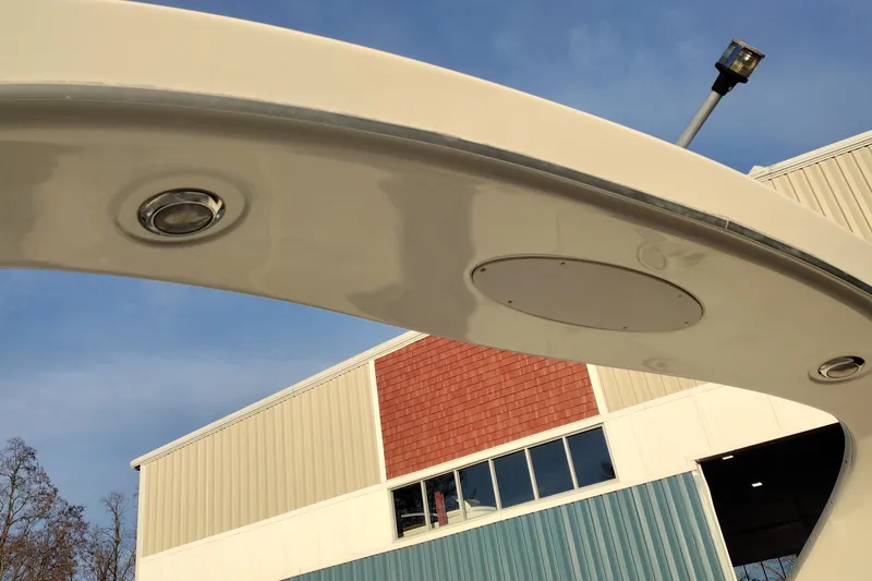 Slide: The Image of 2005 Bayliner 305 boat detail with building and clear sky background. - 48