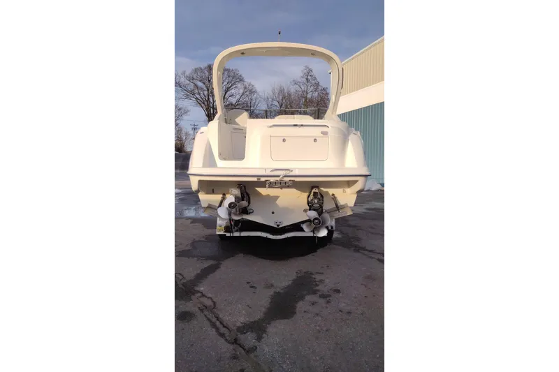 Slide: The Image of 2005 Bayliner 305 boat rear view, parked outdoors on pavement. - 7