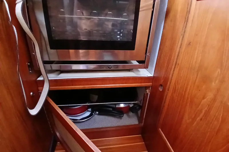 Slide: The Image of 1983 Wauquiez Hood yacht interior with wooden cabinetry and built-in oven. - 12