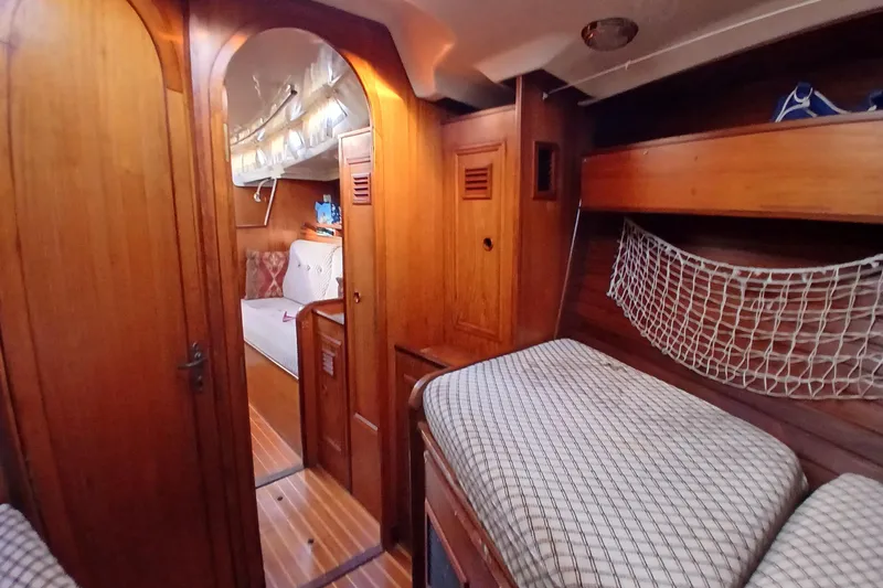 Slide: The Image of Interior of 1983 Wauquiez Hood sailboat with wooden finish and cozy sleeping area. - 16