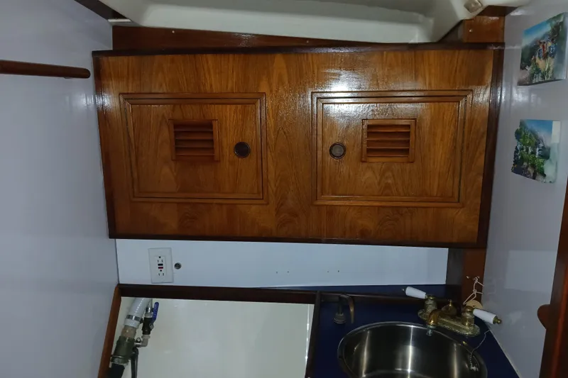 Slide: The Image of Wooden cabinet and sink in 1983 Wauquiez Hood boat interior. - 19