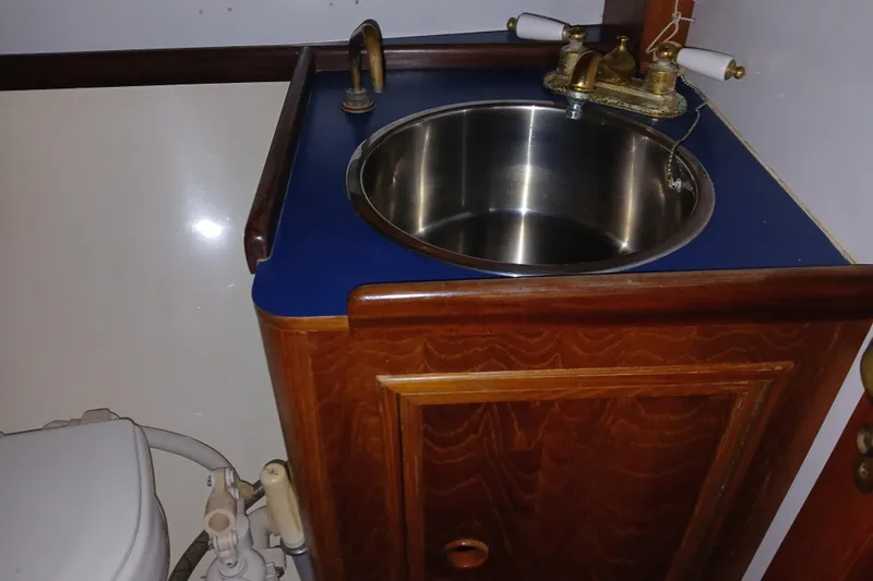 Slide: The Image of 1983 Wauquiez Hood yacht bathroom with wooden cabinet and stainless steel sink. - 20