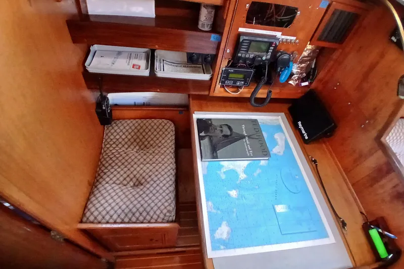 Slide: The Image of Cozy navigation station on 1983 Wauquiez Hood sailboat with map and radio equipment. - 21