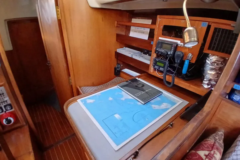 Slide: The Image of Navigation station inside 1983 Wauquiez Hood sailboat with map and communication equipment. - 22
