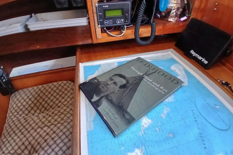 Slide: The Image of Nautical chart table with book "Ted Hood" on a 1983 Wauquiez Hood sailboat. - 24