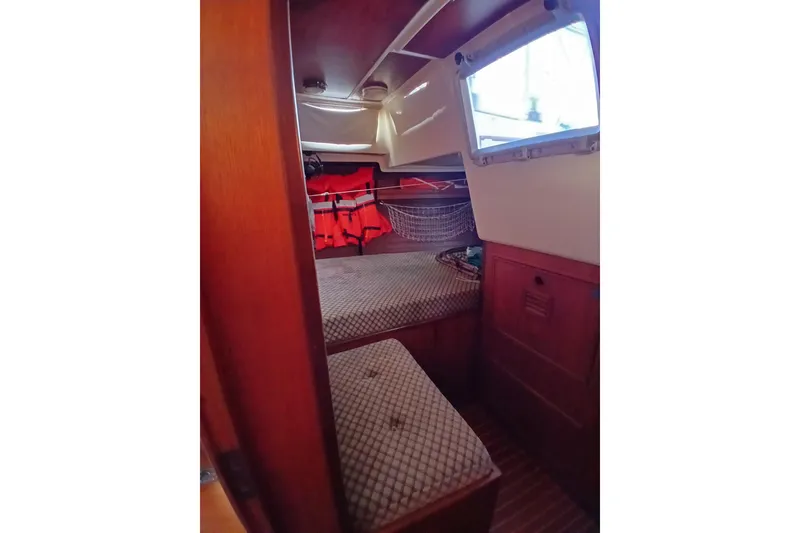 Slide: The Image of Interior cabin of 1983 Wauquiez Hood sailboat with cozy bedding and life jackets. - 28