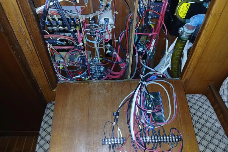 Slide: The Image of Electrical wiring inside a 1983 Wauquiez Hood sailboat, showcasing complex circuitry and connections. - 31