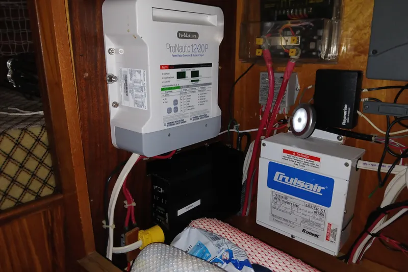 Slide: The Image of Electrical components inside a 1983 Wauquiez Hood boat, featuring ProNautic and Cruisair systems. - 32