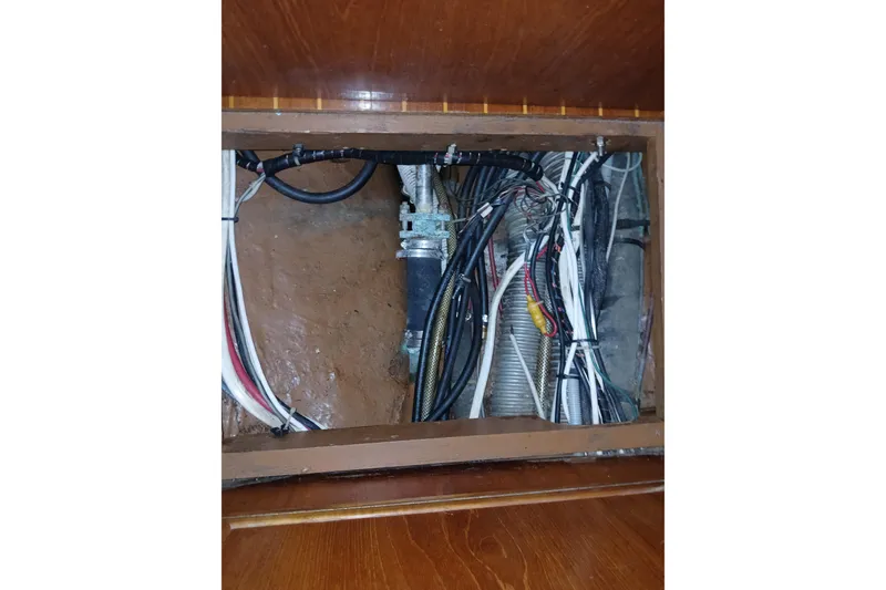 Slide: The Image of Electrical wiring and components inside a 1983 Wauquiez Hood boat, showcasing detailed cabling. - 33