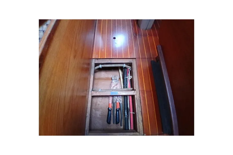 Slide: The Image of 1983 Wauquiez Hood yacht interior with wooden flooring and storage compartment. - 35