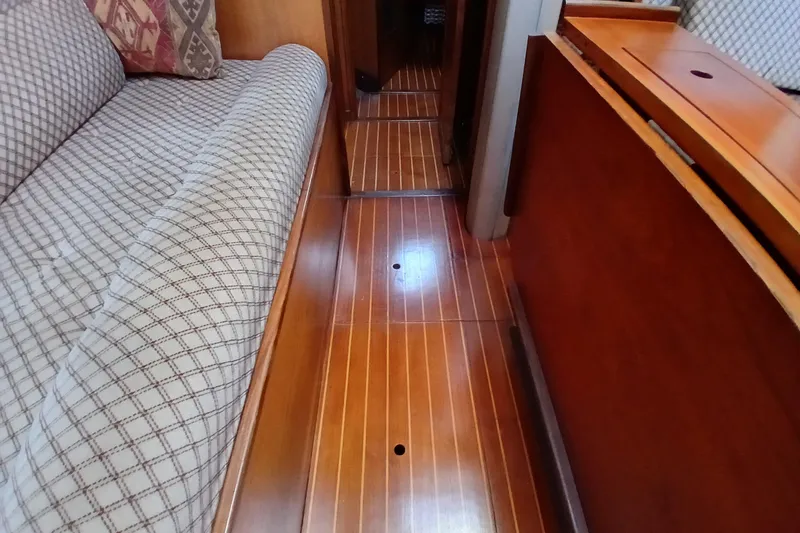 Slide: The Image of Interior of 1983 Wauquiez Hood yacht with wooden flooring and patterned upholstery. - 36