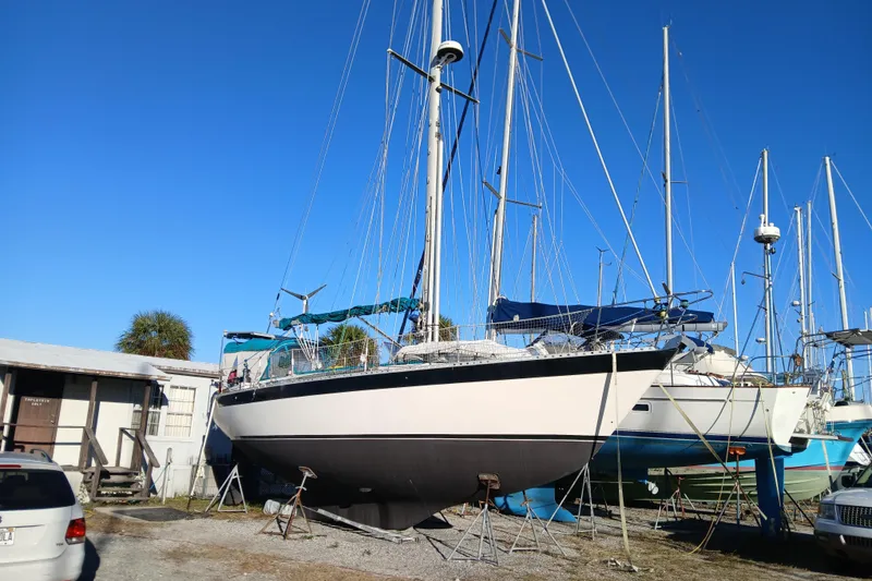 Slide: The Image of 1983 Wauquiez Hood sailboat on dry dock under clear blue sky. - 39