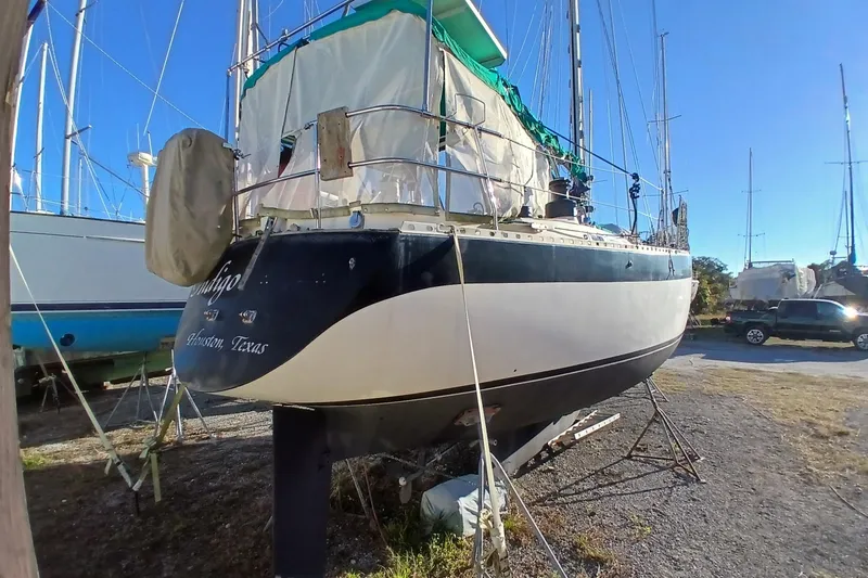 Slide: The Image of 1983 Wauquiez Hood sailboat on land, Houston, Texas, under clear blue sky. - 43