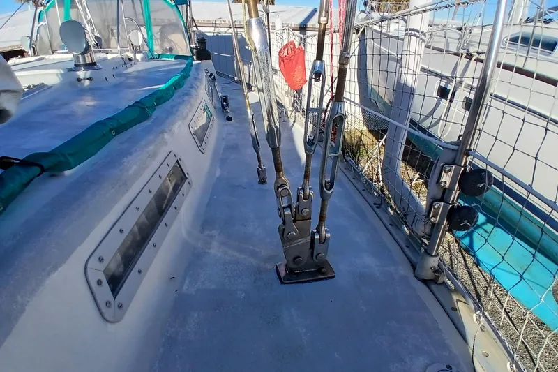 Slide: The Image of 1983 Wauquiez Hood sailboat deck with rigging and safety netting. - 48