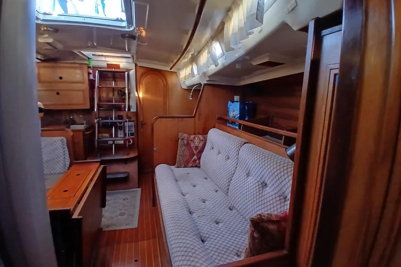 Slide: The Image of Interior of 1983 Wauquiez Hood sailboat with wooden furnishings and cozy seating area. - 6